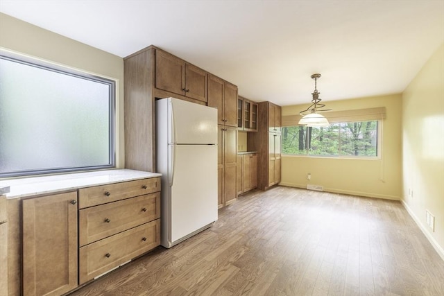 73 Mountain Gate Rd Unit 73, Ashland, MA 01721 - kitchen featuring freestanding refrigerator, light wood finished floors, decorative light fixtures, and baseboards