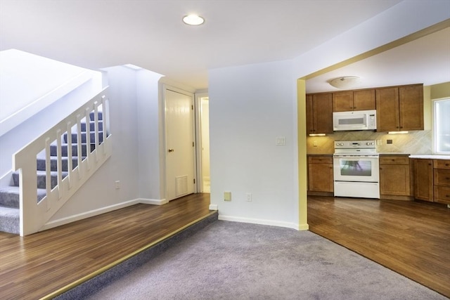 73 Mountain Gate Rd Unit 73, Ashland, MA 01721 - kitchen featuring white appliances, brown cabinets, dark colored carpet, baseboards, and backsplash