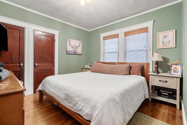 bedroom featuring hardwood / wood-style flooring and ornamental molding