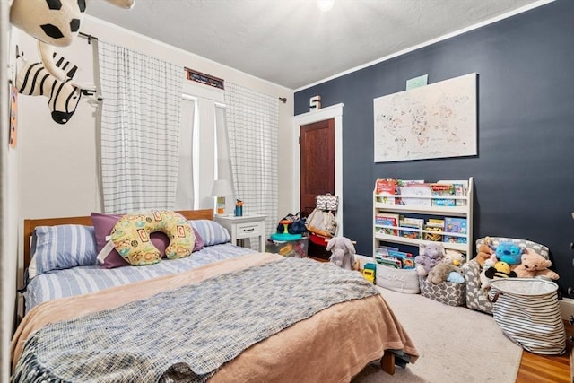 bedroom featuring ornamental molding and hardwood / wood-style floors