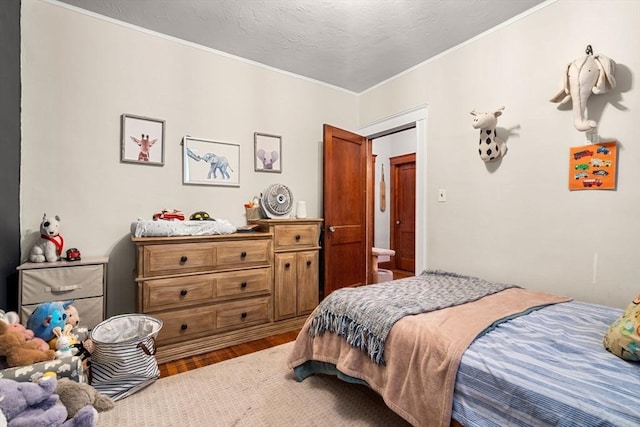 bedroom featuring hardwood / wood-style flooring and ornamental molding