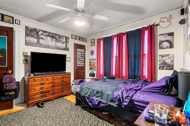 bedroom with ceiling fan and wood-type flooring