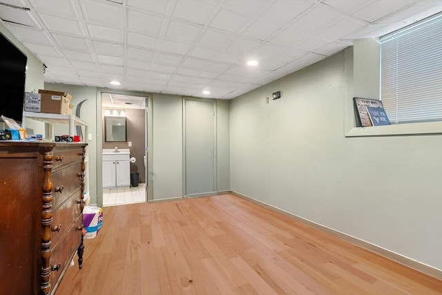 interior space featuring light hardwood / wood-style floors and ensuite bath