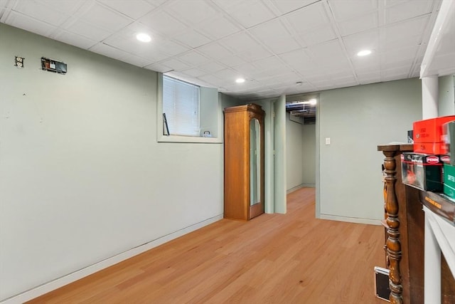 basement with light hardwood / wood-style flooring