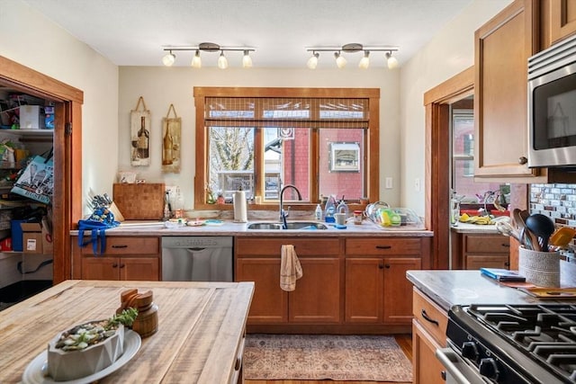 kitchen featuring sink, stainless steel appliances, and decorative backsplash