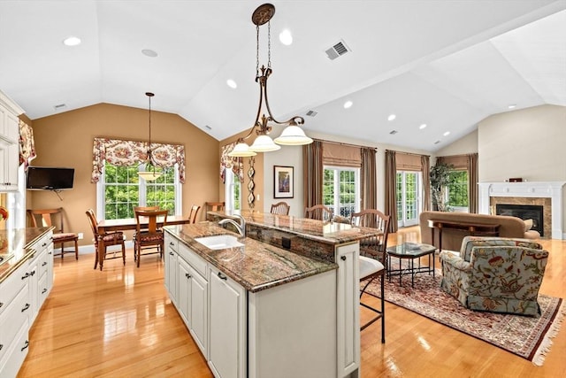 28 Ridgewood Xing Unit 28, Hingham, MA 02043 - kitchen with vaulted ceiling, a breakfast bar area, light wood-style floors, white cabinets, and recessed lighting