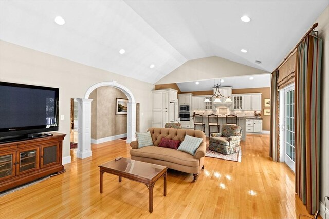 28 Ridgewood Xing Unit 28, Hingham, MA 02043 - living room with decorative columns, vaulted ceiling, light wood-type flooring, arched walkways, and recessed lighting