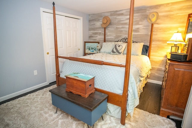 bedroom featuring wood walls and a closet