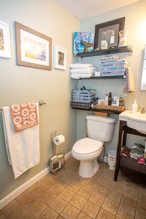 bathroom with toilet and tile patterned floors