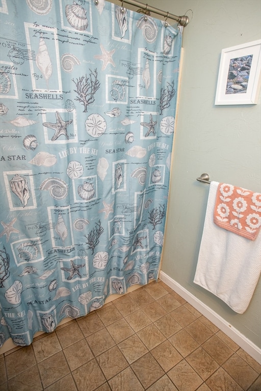 bathroom featuring tile patterned floors and a shower with shower curtain