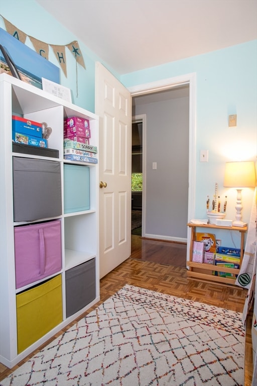 bedroom featuring parquet flooring