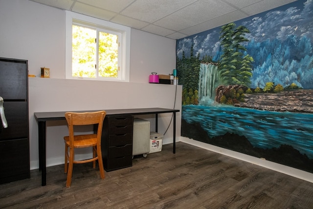 interior space featuring a paneled ceiling and dark wood-type flooring