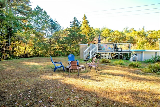 view of yard with an outdoor fire pit and a deck