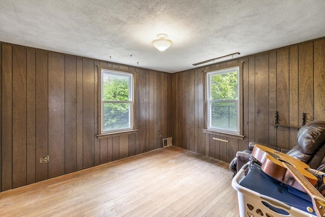 43 Pleasantview St, Ludlow, MA 01056 - sitting room featuring wood-type flooring, wood walls, and a textured ceiling