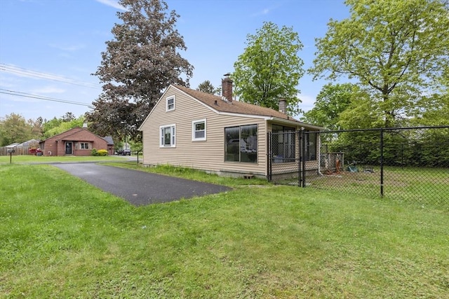 43 Pleasantview St, Ludlow, MA 01056 - rear view of property with a chimney and asphalt driveway