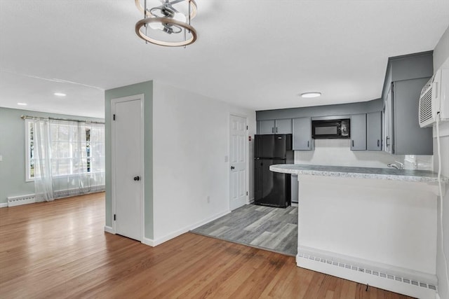 49 Wimbleton Dr, Longmeadow, MA 01106 - kitchen featuring black appliances, light countertops, light wood-type flooring, and baseboards