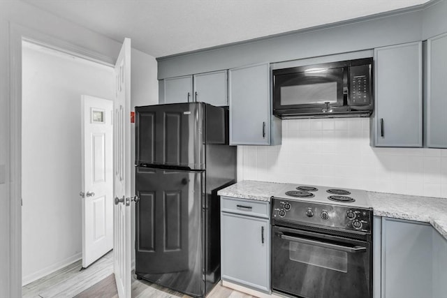49 Wimbleton Dr, Longmeadow, MA 01106 - kitchen featuring black appliances, gray cabinetry, backsplash, light countertops, and light wood finished floors
