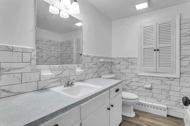 49 Wimbleton Dr, Longmeadow, MA 01106 - bathroom featuring tile walls, vanity, wood finished floors, toilet, and a wainscoted wall