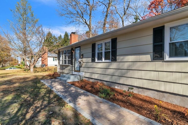49 Wimbleton Dr, Longmeadow, MA 01106 - doorway to property with a chimney