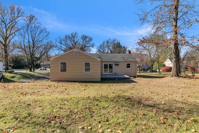 rear view of property featuring a yard