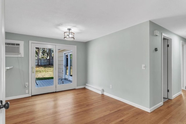 49 Wimbleton Dr, Longmeadow, MA 01106 - doorway to outside with an AC wall unit, light wood-style floors, and baseboards