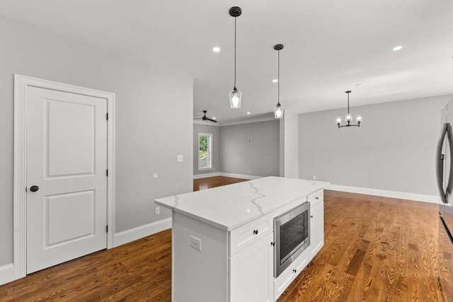 LOT11R 46 Loidie Ln, Brockton, MA 02301 - kitchen featuring stainless steel microwave, white cabinets, pendant lighting, light stone countertops, and dark wood-style floors