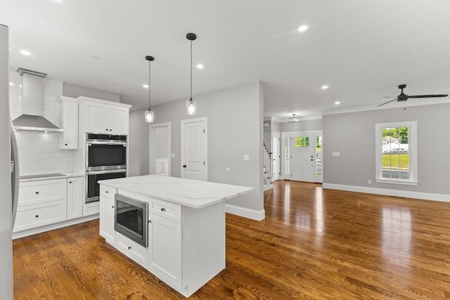 LOT11R 46 Loidie Ln, Brockton, MA 02301 - kitchen with appliances with stainless steel finishes, wall chimney range hood, white cabinetry, open floor plan, and recessed lighting