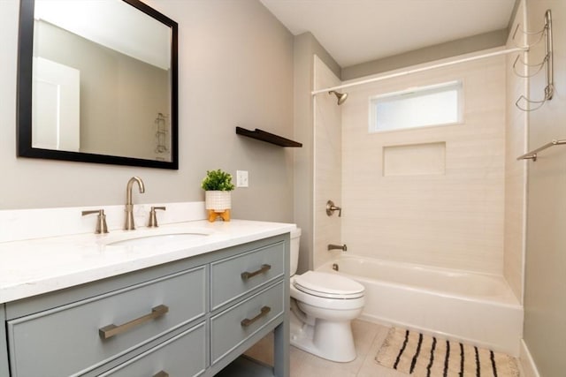 full bathroom with tile patterned flooring, toilet, vanity, and tiled shower / bath