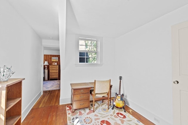 office space with wood finished floors and baseboards