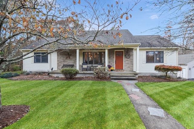 ranch-style house featuring a garage, a front yard, and a porch