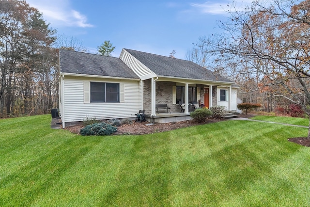 view of front of property with central air condition unit and a front lawn