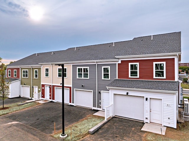 rear view of house featuring a garage