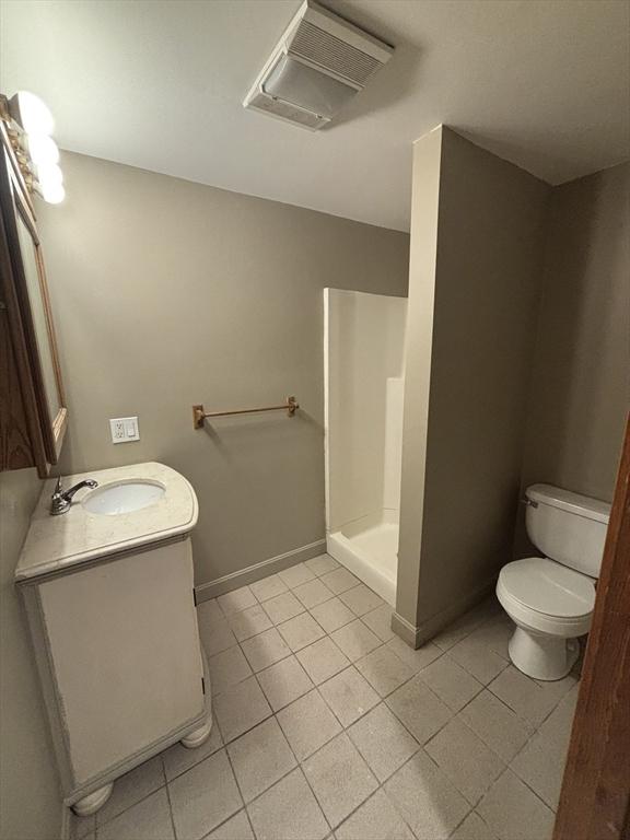 bathroom with toilet, vanity, visible vents, tile patterned floors, and a walk in shower