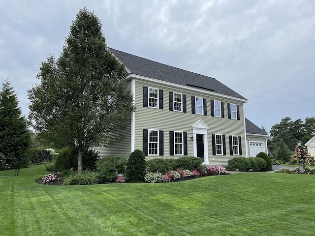 14 Cavite St, Devens, MA 01434 - colonial home with a front yard, an attached garage, and a shingled roof