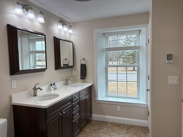 14 Cavite St, Devens, MA 01434 - bathroom featuring double vanity, baseboards, and toilet