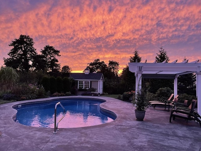 14 Cavite St, Devens, MA 01434 - pool at dusk with a patio, an outbuilding, an outdoor pool, and an exterior structure