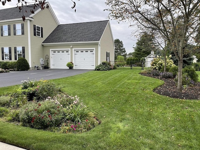 14 Cavite St, Devens, MA 01434 - view of home's exterior featuring an attached garage, asphalt driveway, and a shingled roof