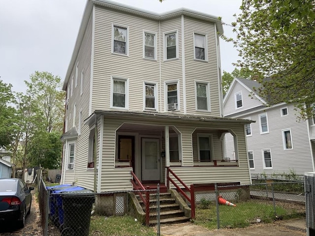81-83 Beaumont St, Springfield, MA 01108 - view of property featuring a fenced front yard, a porch, and cooling unit