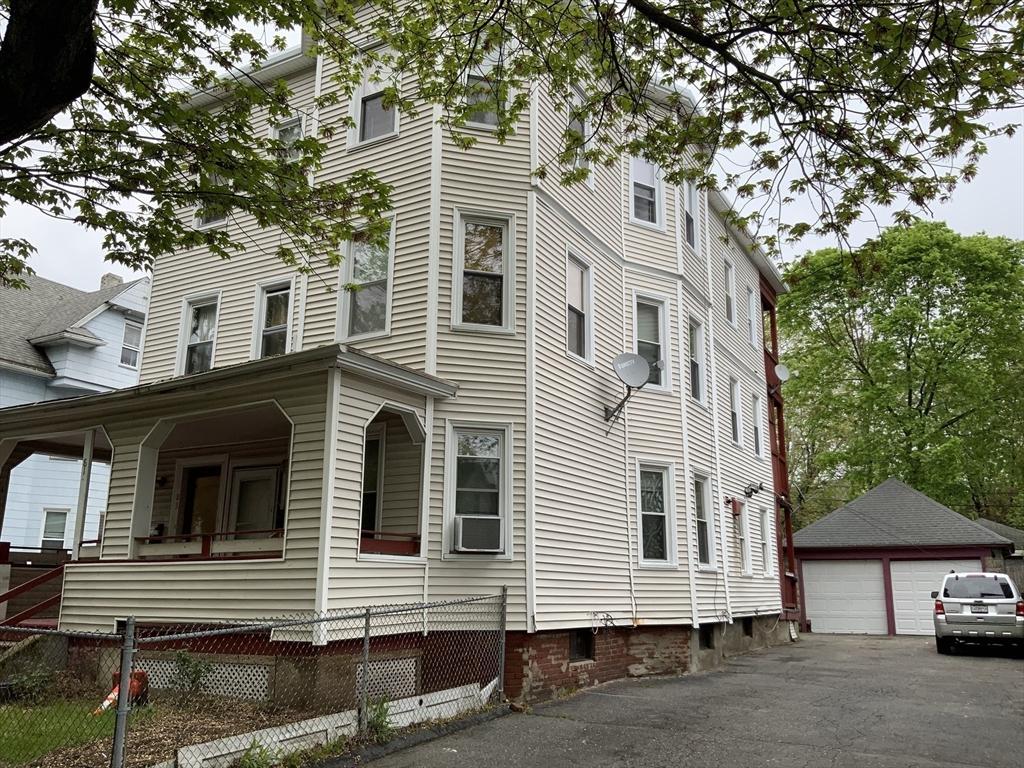 81-83 Beaumont St, Springfield, MA 01108 - view of home's exterior with a garage and an outbuilding