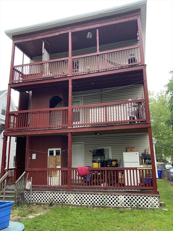 81-83 Beaumont St, Springfield, MA 01108 - rear view of property with a balcony and a yard