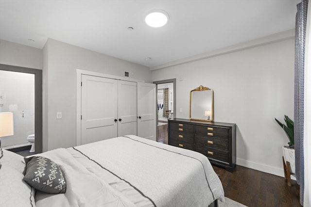 bedroom featuring visible vents, baseboards, ensuite bath, dark wood-style flooring, and a closet