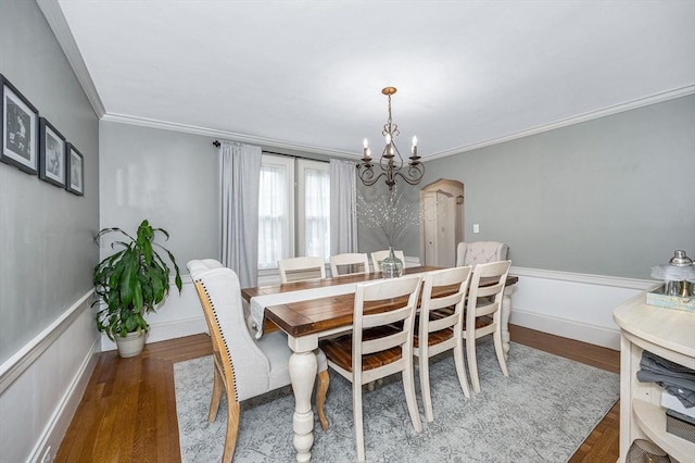 11 Florence Rd, Lowell, MA 01851 - dining room with a chandelier, wood finished floors, crown molding, arched walkways, and baseboards