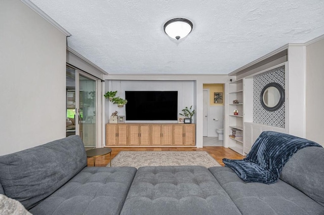 11 Florence Rd, Lowell, MA 01851 - living room with a textured ceiling, ornamental molding, wood finished floors, and built in features