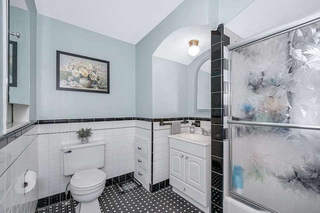 11 Florence Rd, Lowell, MA 01851 - full bath with tile walls, toilet, a shower with door, vanity, and wainscoting