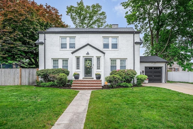 11 Florence Rd, Lowell, MA 01851 - view of front of house with concrete driveway, brick siding, a chimney, and an attached garage