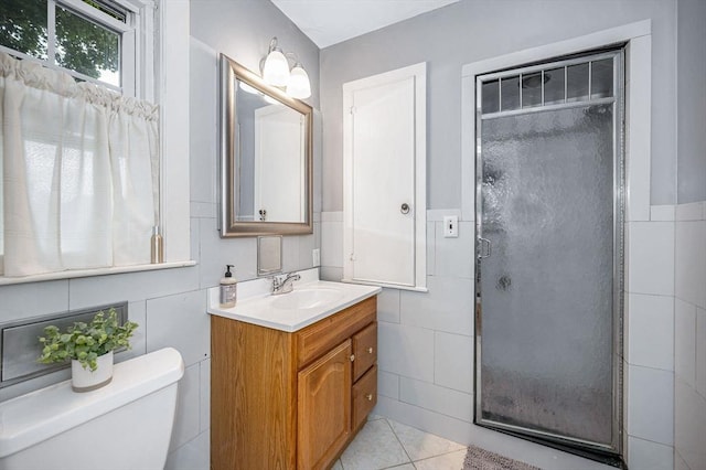 11 Florence Rd, Lowell, MA 01851 - bathroom with tile walls, vanity, a stall shower, toilet, and tile patterned flooring