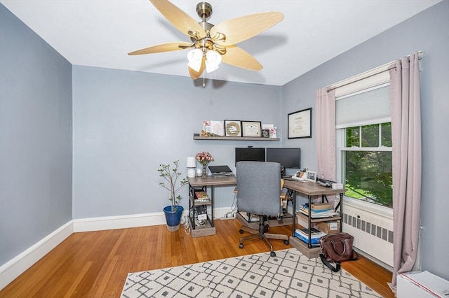 11 Florence Rd, Lowell, MA 01851 - home office with radiator, wood finished floors, a ceiling fan, and baseboards