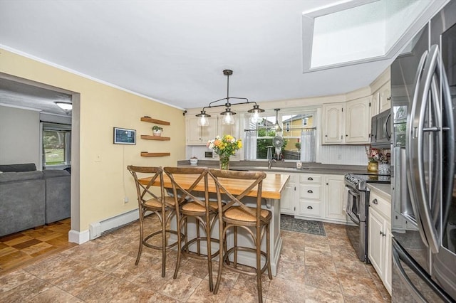 11 Florence Rd, Lowell, MA 01851 - kitchen with appliances with stainless steel finishes, crown molding, a baseboard radiator, baseboards, and pendant lighting