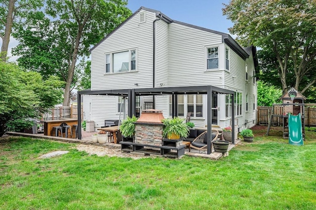 11 Florence Rd, Lowell, MA 01851 - back of property with a playground, a patio area, and outdoor lounge area