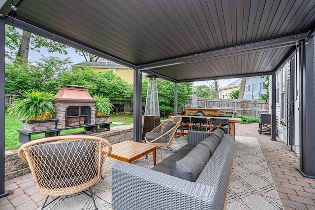 11 Florence Rd, Lowell, MA 01851 - fenced backyard with an outdoor living space with a fireplace, outdoor dining area, and a patio area